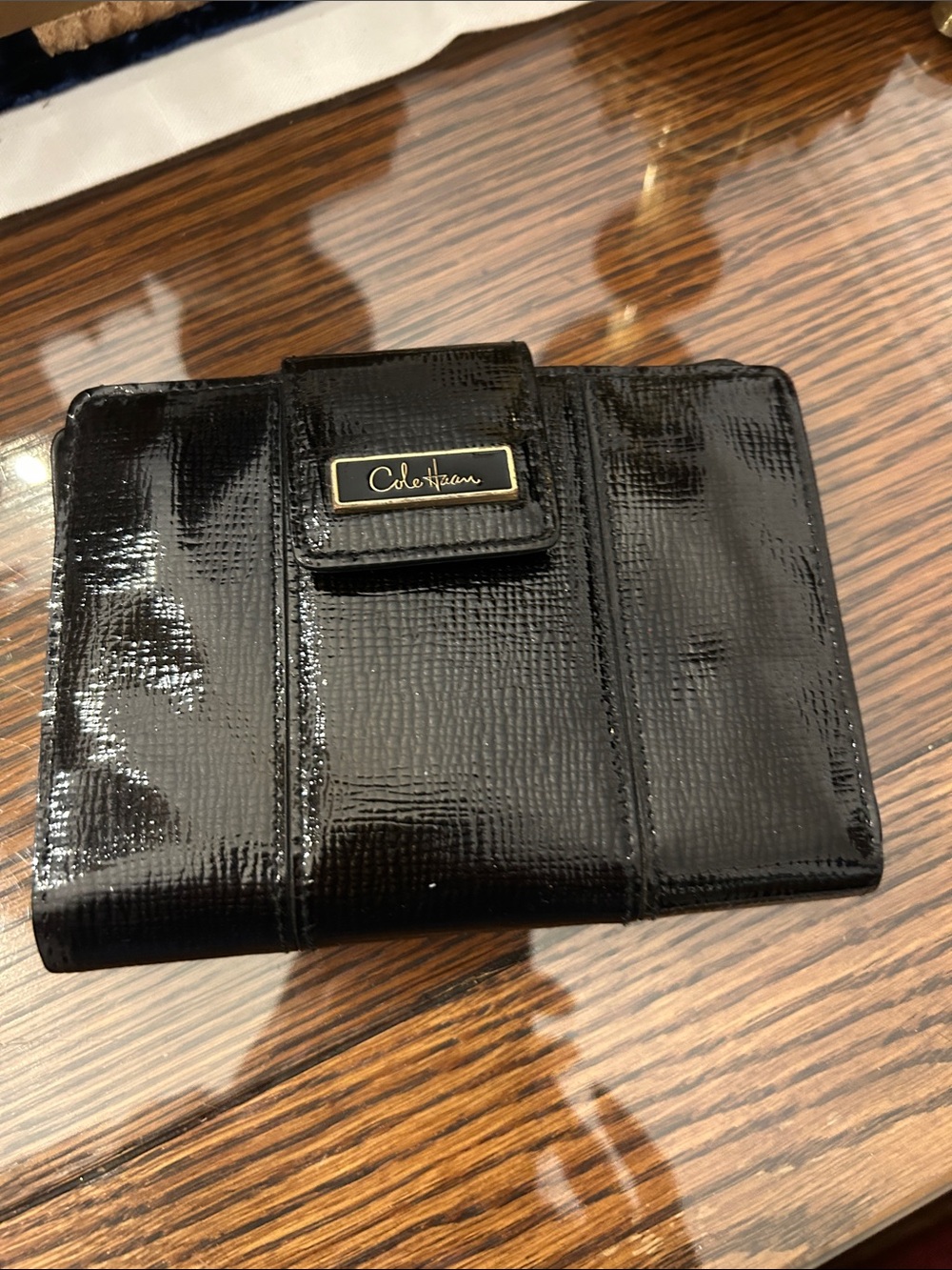 Cole Haan Glossy Black Patent Leather Wallet with Gold Logo